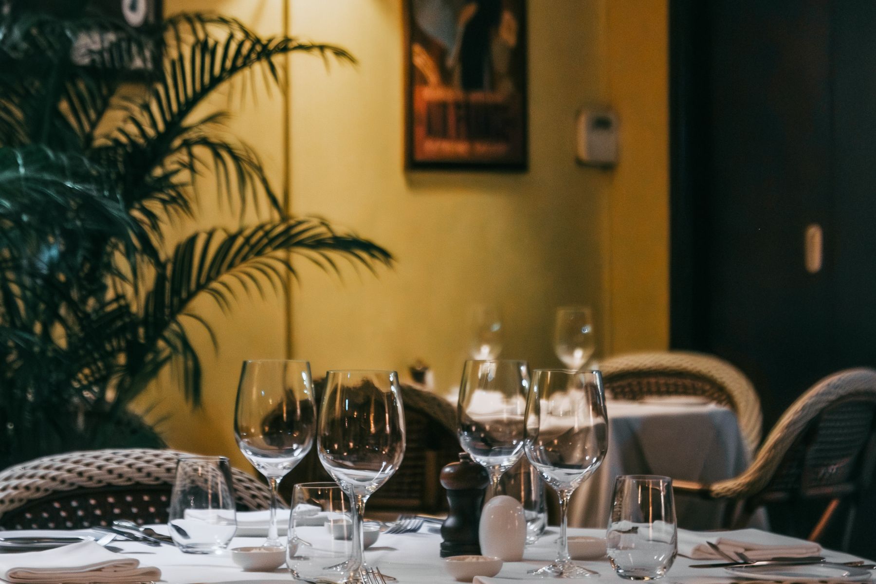 An intimate restaurant dining room glowing in warm evening light